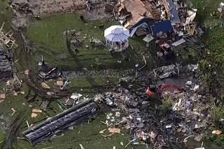 Wreckage is strewn across a property the day after a deadly series of tornados in Texas