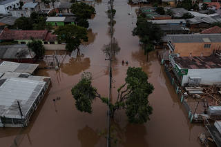 The Wider Image: Flood-battered farmers in southern Brazil wade through lost harvests