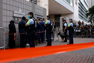 Police stand guard outside the West Kowloon Magistrates' Courts building, before the verdict of the 47 pro-democracy activists charged under the national security law, in Hong Kong