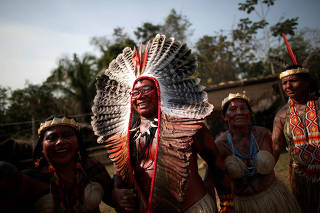 Indigenous people from the Shanenawa tribe dance during a festival in the indigenous village of Morada Nova near Feijo
