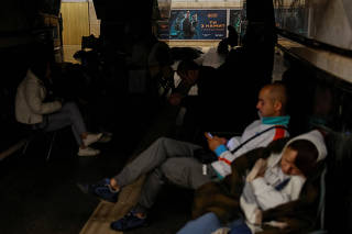 People take shelter inside a metro station during a Russian military attack, in Kyiv