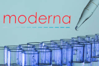 FILE PHOTO: Test tubes are seen in front of a displayed Moderna logo in this illustration