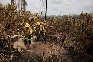 Brazilian Institute of Environment and Renewable Natural Resources (IBAMA) fire brigade members combat fires in Yanomami Indigenous land