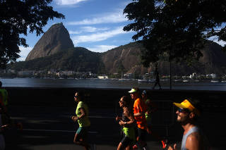 Runners take part in the 42K Marathon in Rio de Janeiro
