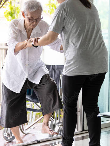 ARQUIVO Nº:  400688314 -- Asian caregiiver help care to senior grandmother walk,woman holding hands of the old elderly for support,walking up from a different level floor,safety,prevent accident at nursing home,service . Credit  Satjawat / Adobe Stock