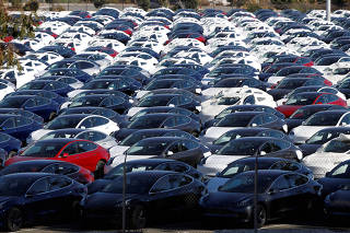 FILE PHOTO: A parking lot of predominantly new Tesla Model 3 electric vehicles is seen in Richmond, California