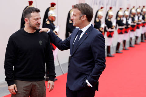 France's President Emmanuel Macron (R) greets Ukraine?s President Volodymyr Zelensky upon hs arrival to attend the International commemorative ceremony at Omaha Beach marking the 80th anniversary of the World War II 