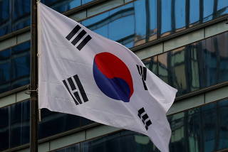 FILE PHOTO: A flag bearing the logo of Samsung flutters in front of its office building in Seoul