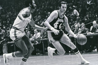 The Los Angeles Lakers guard Jerry West dribbles past Walt Frazier of the New York Knicks, in 1972. (The New York Times)