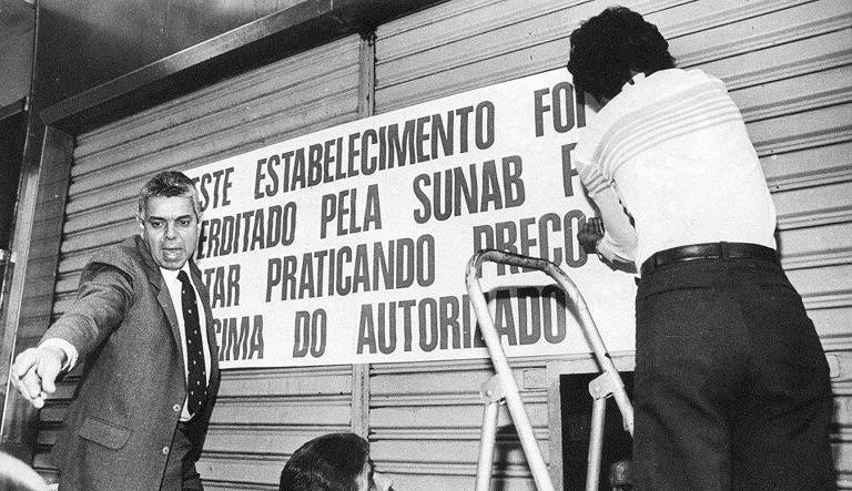 RIO DE JANEIRO, RJ, 17.07.1986: PREÇOS-FISCALIZAÇÃO - Fiscais da Sunab colocam cartaz e interditam Casa José Silva, na rua do Ouvidor no centro do Rio de Janeiro, por desrespeitar o congelamento de preços do Plano Cruzado. (Foto: Rogério Carneiro/Folhapress) [FSP-Dinheiro-25.02.96]