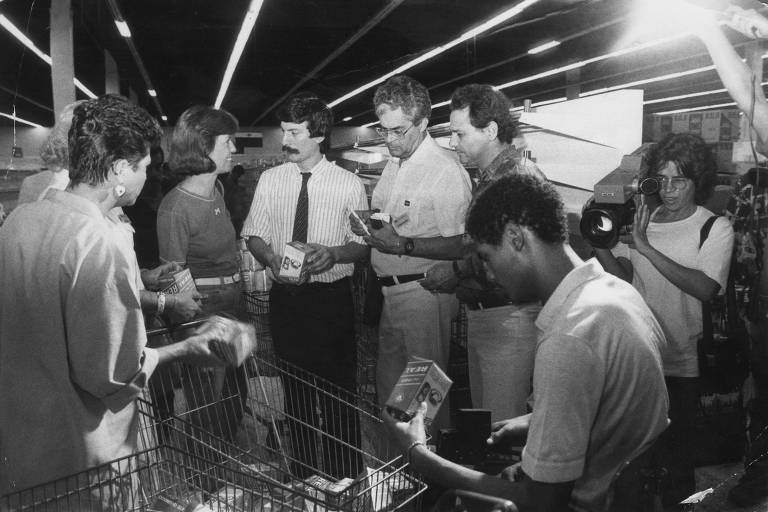 ORG XMIT: 173801_0.tif SÃO PAULO, SP, BRASIL, 09-03-1986: Paul Houy, diretor do Carrefour da Marginal Pinheiros (de gravata) convidou vários clientes para acompanhá-lo na conversão da moeda, de Cruzado para Cruzeiro. (Foto: Matuiti Mayezo/Folhapress, 0829 - Negativo: SP 01993-1986)