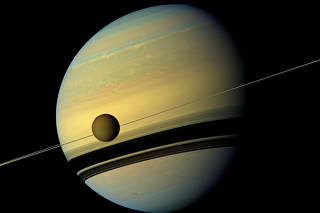 FILE PHOTO: Handout of Titan, Saturn's largest moon in this natural color view from NASA's Cassini spacecraft