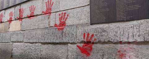 (FILES) Red hands graffitis are seen on the 