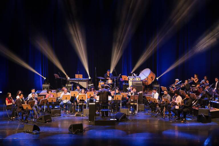 Orquestra toca instrumentos em um palco