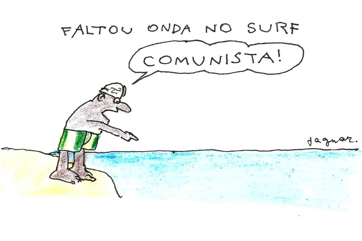 Sob o título 'Faltou onda no surf, a imagem é uma charge que mostra um homem de pé na areia, usando um chapéu e sunga verde, olhando para o mar. Ele está apontando para a água e diz: 'COMUNISTA!'. A cena é simples, com um fundo branco e um mar azul claro.