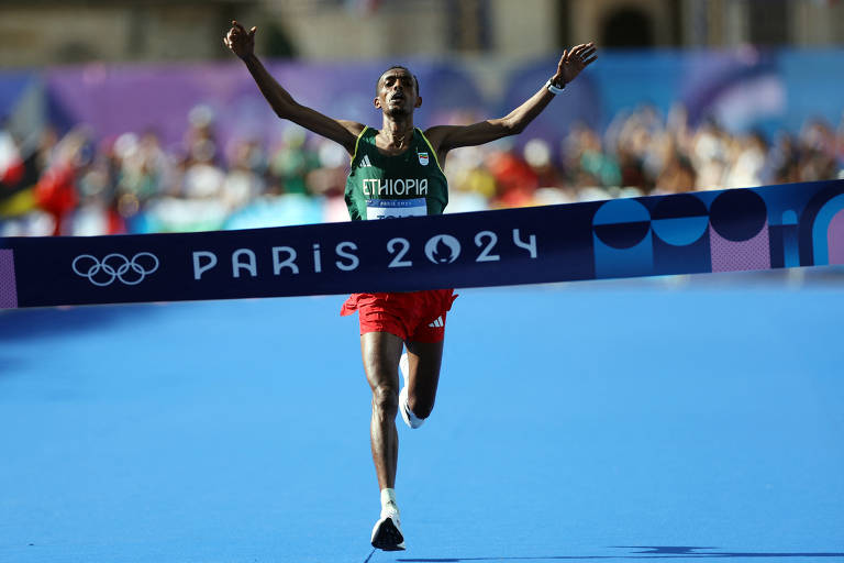 O etíope Tamirat Tola cruza a linha de chegada e vence a maratona olímpica, em Paris; veja fotos de hoje