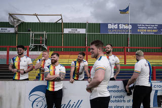 Players from the Keighley Cougars rest after winning their rugby match against the North Wales Crusaders in Keighley, England, on April 14, 2024. (Mary Turner/The New York Times)