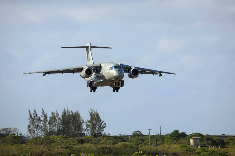 Avião grande, com dois motores a jato, em procedimento de pouso. O céu está azul