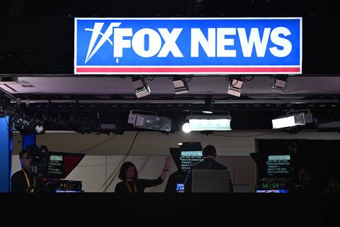 News anchors work at Fox News' booth during the second day of the 2024 Republican National Convention at the Fiserv Forum in Milwaukee, Wisconsin, July 16, 2024. Days after he survived an assassination attempt Donald Trump won formal nomination as the Republican presidential candidate and picked right-wing loyalist J.D. Vance for running mate, kicking off a triumphalist party convention in the wake of last weekend's failed assassination attempt. (Photo by Patrick T. Fallon / AFP)