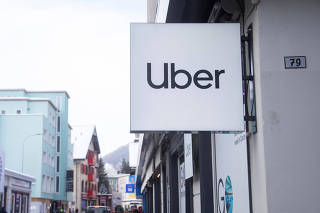 Logo of Uber is seen at a temporary showroom during the World Economic Forum in Davos