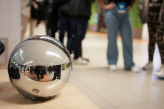 FILE PHOTO: People queue to use WorldCoin's iris-scanners in Madrid