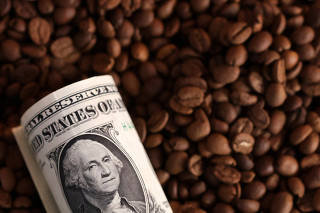 Illustration shows coffee beans and U.S. dollar banknote