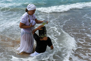 Devotees of Candomble take part in a spiritual cleansing ritual, on New Year's Eve in Rio de Janeiro