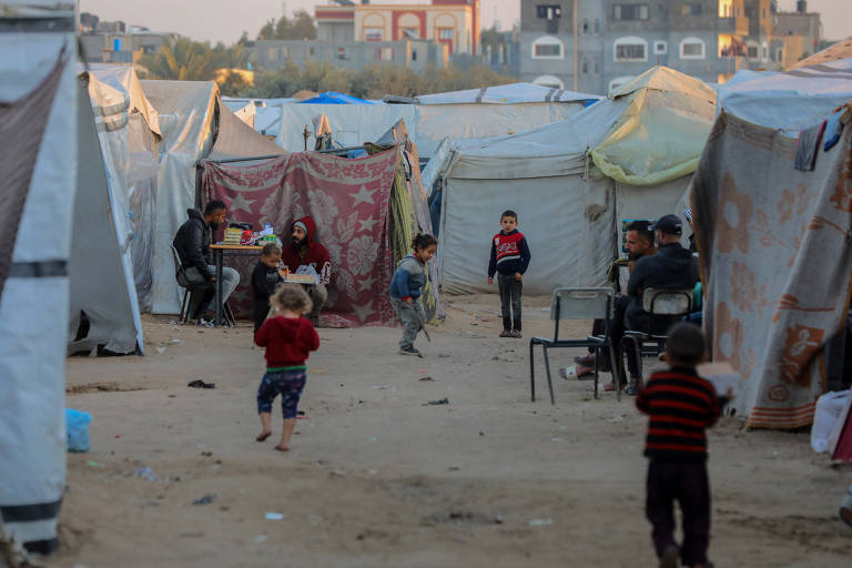 Crianças palestinas deslocadas são retratadas em abrigo na cidade de Deir al-Balah, na região central da Faixa de Gaza