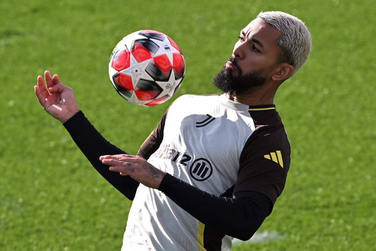 O volante Douglas Luiz mata a bola no peito em treino da Juventus em Turim para partida da Champions League contra o Benfica 