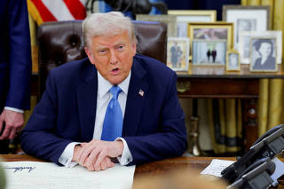 FILE PHOTO: U.S. President Donald Trump signs an executive order in the Oval Office at the White House