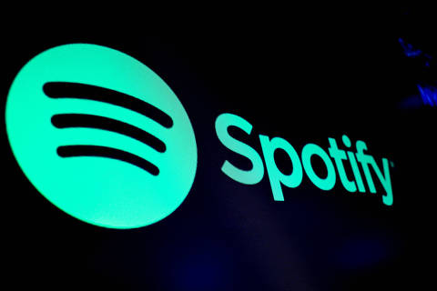 FILE PHOTO: FILE PHOTO: A screen displays the logo of Spotify on the floor at the New York Stock Exchange (NYSE) in New York City, U.S., December 4, 2023.  REUTERS/Brendan McDermid/File Photo/File Photo ORG XMIT: FW1