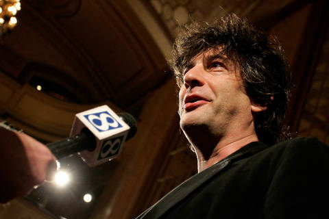 FILE PHOTO: British author Neil Gaiman talks to a reporter as he arrives at the premiere of the animated movie 