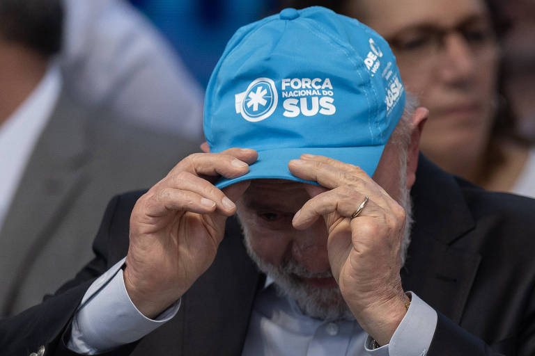 Lula segura na cabeça boné azul claro com inscrição quot;Força Nacional do SUSquot;