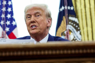 FILE PHOTO: U.S. President Donald Trump signs executive orders for reciprocal tariffs in Washington