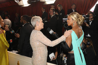 Jamie Lee Curtis, left, and Laverne Cox, who became the red-carpet host of ÒLive From E!Ó in December 2021, at the 95th Academy Awards in Los Angeles, March 12, 2023. (Sinna Nasseri/The New York Times)