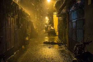 Rain pours onto the body of Romeo Torres Fontanilla, who was gunned down, witnesses said, by two unknown men on a motorbike, in the Pasay district of Manila, Philippines.