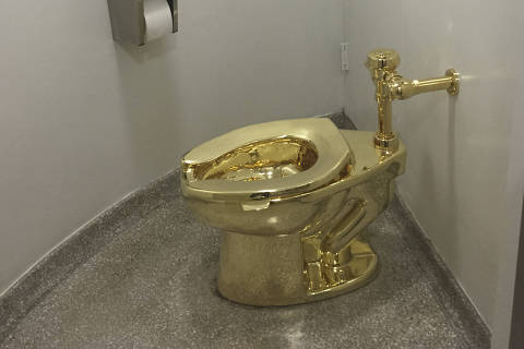 (FILES) A fully functioning solid gold toilet, made by Italian artist Maurizio Cattelan, is going into public use at the Guggenheim Museum in New York on September 15, 2016. It took just five minutes to steal a £2.8 million gold toilet, which has never been found, from an art exhibition at an English country house, a court heard on February 24, 2025. The fully functioning 18-carat convenience, dubbed 