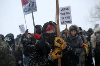 FILE PHOTO: A Native American man leads a protest march near Standing Rock Indian Reservation, North Dakota