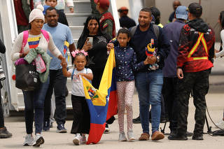 Venezuelan migrants arrive on repatriation flight from Mexico