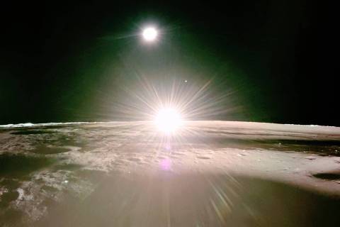 This handout photograph taken by Firefly Aerospace on March 16, 2025 and released on March 18, shows the lunar surface and the setting sun with Earth and Venus on the horizon, during the lunar mission of Firefly's Blue Ghost lunar lander. The private US lander has captured eerie high-definition images of a lunar sunset, which NASA hopes to use to unravel the mystery of a haze first observed on the Moon in the 1960s. (Photo by HANDOUT / Firefly Aerospace / AFP) / RESTRICTED TO EDITORIAL USE - MANDATORY CREDIT 