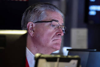 Traders work on the floor of the NYSE in New York