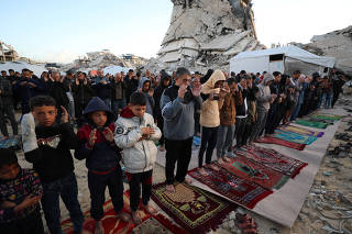 Palestinian Muslims attend Eid al-Fitr prayer in Jabalia