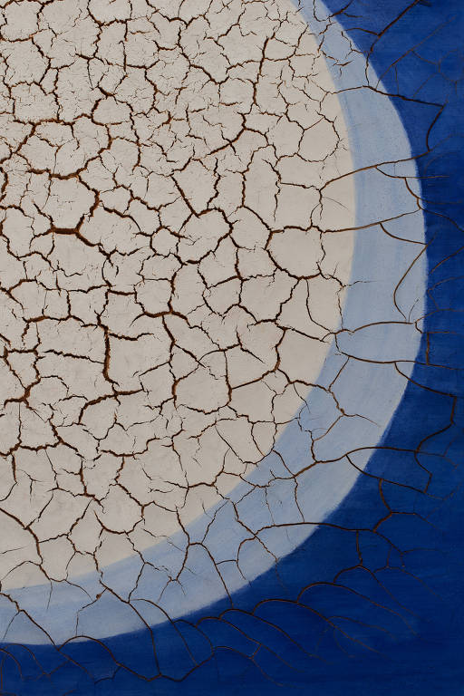 A imagem apresenta uma superfície com um padrão de rachaduras, predominantemente em tons claros, cercada por uma borda azul. O centro da imagem é uma área clara com muitas fissuras, enquanto o fundo azul contrasta com a textura craquelada.