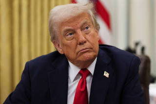 U.S. President Donald Trump signs an executive order in the Oval Office, in Washington