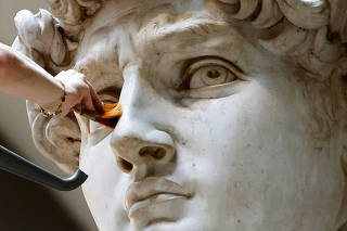 Michelangelo's statue of David gets a cleaning at the Galleria dell'Accademia, in Florence