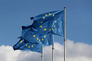 FILE PHOTO: European Union flags fly outside the EU Commission headquarters in Brussels
