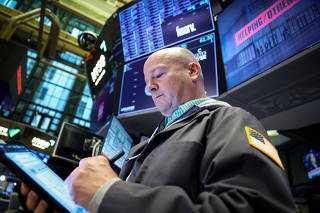 Traders work on the floor of the NYSE in New York