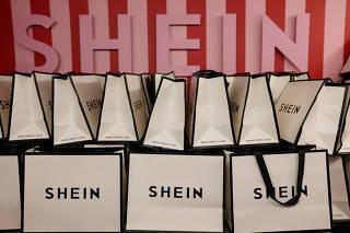FILE PHOTO: A company logo for fashion brand Shein is seen on a pile of gift bags on its Christmas bus as part of a nationwide promotional tour in Liverpool, Britain