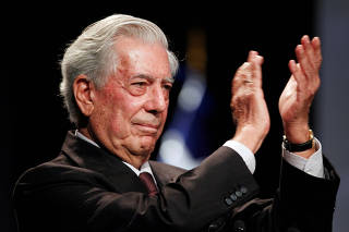 FILE PHOTO: Vargas Llosa, 2010 Nobel Prize for Literature applauds during the opening ceremony of an international seminar in Lima