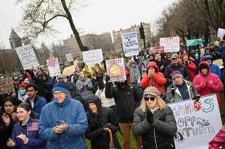 Demonstrators rally on Cambridge Common in a protest organized by the City of Cambridge against interference by the federal government, in Cambridge
